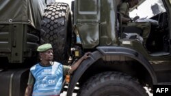 Un chauffeur militaire des Forces armées de la République démocratique du Congo (FARDC) devant des camions militaires alignés le long du boulevard principal le 29 octobre 2018 à Kinshasa.