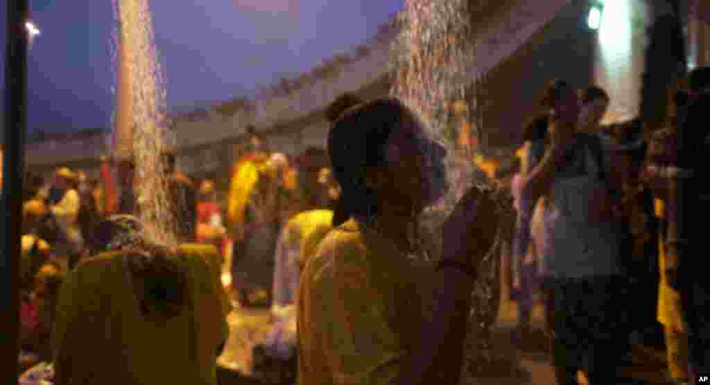 Traditionally, devotees would bathe by the river as part of a ritual of Thaipusam. However, in modern-day Thaipusam, devotees are provided shower heads instead. (VOA - Yong YN)