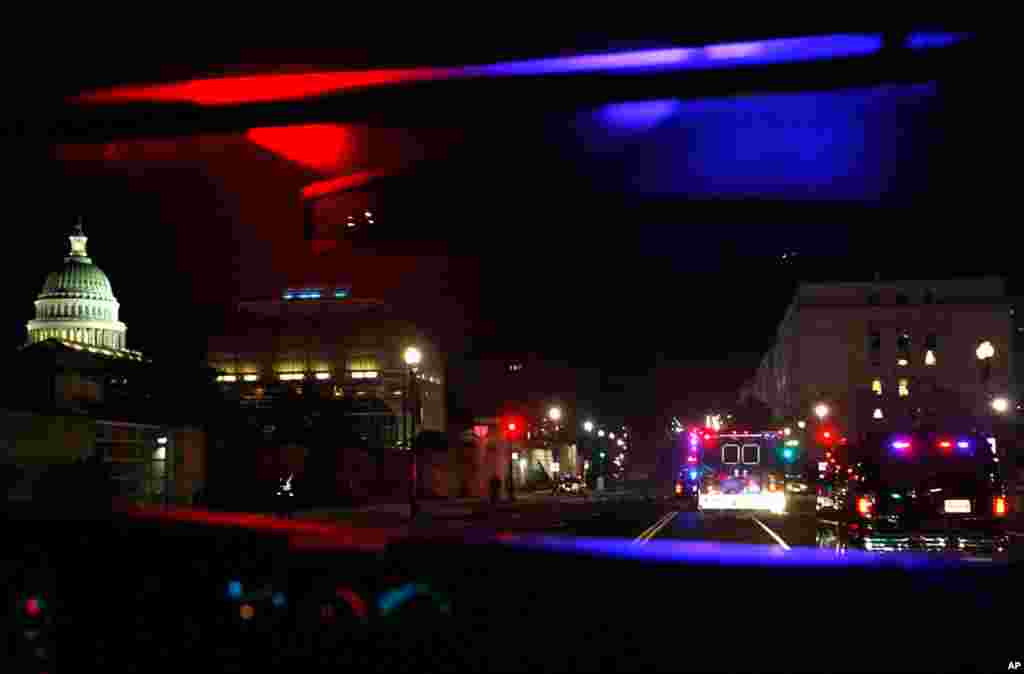 Lights from the motorcade carrying the president are reflected as the motorcade heads to the U.S. Capitol. (AP)