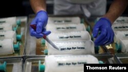 Cakes in the shape of syringes are seen at the Schuerener Backparadies bakery, as the vaccination rollout against the coronavirus disease (COVID-19) continues, in Dortmund, Germany, January 8, 2021.