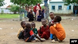 Displaced children share a meal provided through a charity initiative at a camp in Gedaref, Sudan, on July 13, 2024. The World Health Organization said on July 16 that hunger is prompting people to flee Sudan.