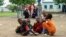 Displaced children share a meal provided through a charity initiative at a camp in Gedaref, Sudan, on July 13, 2024. The World Health Organization said on July 16 that hunger is prompting people to flee Sudan.