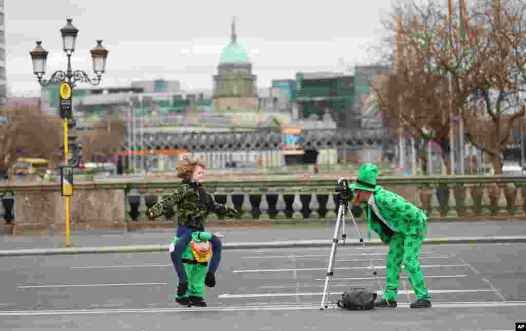 People dressed up for St. Patricks Day take a picture at the Dublin City Center. St Patrick&#39;s Day parades across Ireland were canceled due to the coronavirus pandemic.