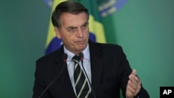 Brazil's President Jair Bolsonaro speaks during a ceremony where he signed a decree loosening restrictions on owning a firearm at Planalto presidential palace in Brasilia, Brazil, Tuesday, Jan. 15, 2019. 