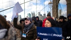 FILE - People shout slogans as they march across the Brooklyn Bridge in solidarity with the Jewish community after recent string of anti-Semitic attacks throughout the greater New York area, Jan. 5, 2020, in New York. 