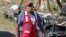 FILE - A Red Cross volunteer wears a face mask while visiting tornado-damaged residences in Prentiss, Miss., April 14, 2020. Additional storms on April 19, 2020, were blamed for three deaths. 