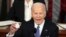 FILE—President Joe Biden holds up a Laken Riley Botton as he delivers the State of the Union address to a joint session of Congress at the U.S. Capitol, Thursday March 7, 2024, in Washington. 