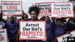 Activists hold placards during a protest against alleged rape at Moi Girls High School, a prestigious government boarding school, in Nairobi, Kenya, June 11, 2018. Accusations were also made at Maasai Girls High School in Kenya's Narok County.