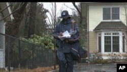 FILE - A U.S. Postal Service employee delivers mail in Washington, D.C.