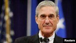 FILE - Former FBI Director Robert Mueller pauses during his remarks at a farewell ceremony held for him at the Justice Department in Washington.