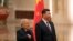 Salvadoran President Salvador Sanchez Ceren (L) standing next to Chinese President Xi Jinping, places his hand on his chest as the national anthem of El Salvador is played during a welcome ceremony held at the Great Hall of the People in Beijing, Nov. 1, 2018.