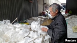 A man sorts plastic waste at Minh Khai Craft Village in Hung Yen province, Vietnam, February 26, 2024.