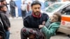 A man carries a child rescued from the rubble of a collapsed building to receive medical care at the Ahli Arab hospital, also known as the Baptist hospital, in Gaza City on Jan, 4, 2025, amid the war in the Palestinian territory between Israel and Hamas. 