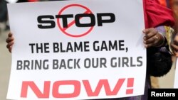 A woman carries a sign as she attends a protest demanding the release of abducted secondary school girls in the remote village of Chibok, in Lagos May 9, 2014. 