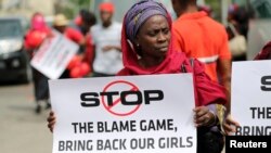 A woman carries a sign as she attends a protest demanding the release of abducted secondary school girls in the remote village of Chibok, in Lagos May 9, 2014. 