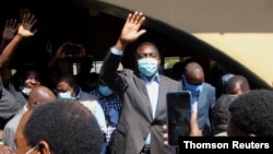 Opposition UPND party's presidential candidate Hakainde Hichilema waves to supporters after casting his ballot in Lusaka, Zambia