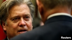 U.S. President Donald Trump's chief strategist Steve Bannon speaks with Homeland Security Secretary John Kelly during Trump's meeting with cyber security experts in the Roosevelt Room of the White House, Jan. 31, 2017. 