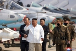 FILE - In this undated file photo provided by the North Korean government on April 12, 2020, North Korean leader Kim Jong Un inspects an air defense unit in western area, North Korea.