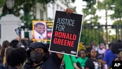 FILE - Demonstrators stand in front of the governor's mansion after a march from the state Capitol in Baton Rouge, La., May 27, 2021, protesting the death of Ronald Greene, who died in the custody of Louisiana State Police in 2019. 