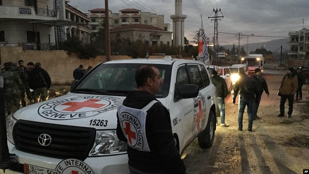 FILE - The International Committee of the Red Cross, working alongside the Syrian Arab Red Crescent (SARC) and the United Nations, shows a convoy containing food, medical items, blankets and other materials being delivered to the town of Madaya in Syria, Jan. 11, 2016