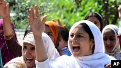 FILE - Pakistani Kashmiris protest against India, in Muzaffarabad, the capital of Pakistani Kashmir, Aug. 20, 2019. 