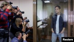 (FILE) Reporter Evan Gershkovich stands inside an enclosure before a court hearing in Moscow, Russia.