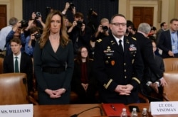 FILE - Jennifer Williams, special adviser to Vice President Mike Pence and Lt. Colonel Alexander Vindman, director for European Affairs at the National Security Council, prepare to testify before the House Intelligence Committee, Nov. 19, 2019.