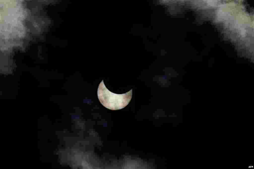 A view of a partial solar eclipse as seen from the town of Givatayim near Tel Aviv, Israel, Tuesday, Jan. 4, 2011. A partial solar eclipse began Tuesday in the skies over the Mideast and will extend across much of Europe. (AP Photo/Ariel Schalit)