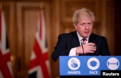 Britain's Prime Minister Boris Johnson speaks during a news conference in response to the ongoing situation with the coronavirus disease (COVID-19) pandemic, at 10 Downing Street, London, Britain, Dec. 19, 2020.