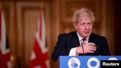 Britain's Prime Minister Boris Johnson speaks during a news conference in response to the ongoing situation with the coronavirus disease (COVID-19) pandemic, inside 10 Downing Street, London ,Britain, Dec. 19, 2020.
