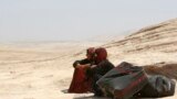 Syrian refugees take a rest as they cross into Iraq at the Peshkhabour border point in Dahuk. Around 30,000 Syrians, the vast majority of them Kurds, have fled the region over a five-day stretch and crossed the border to the self-ruled Kurdish region of northern Iraq.