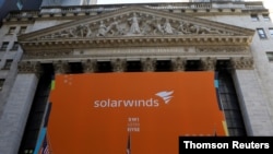 FILE - SolarWinds Corp banner hangs at the New York Stock Exchange (NYSE) on the Initial Public Offering day of the company in New York, Oct. 19, 2018.