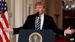 FILE - President Donald Trump speaks in the East Room of the White House in Washington, Jan. 31, 2017. The White House claims Trump's executive order blocking the settlement of Syrian refugees in the U.S. and temporarily barring entry to the U.S. for citizens of seven majority-Muslim nations is "lawful and appropriate." 