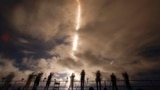 A time exposure shows photographers as they document the SpaceX Falcon 9 rocket with a crew of four as it launches from pad 39A at the Kennedy Space Center in Cape Canaveral, Florida, Sept. 9, 2024. 