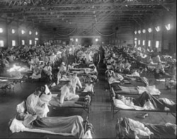 FILE - Influenza victims crowd into an emergency hospital near Fort Riley, Kansas in 1918, when the Spanish flu pandemic killed at least 20 million people worldwide.