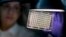 FILE - A microbiologist reads a panel to check on a bacterium's resistance to an antibiotic in the Infectious Disease Laboratory at the federal Centers for Disease Control and Prevention in Atlanta.