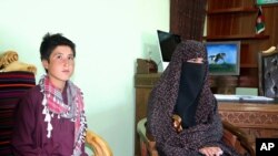 Qamar Gul, 15, right, and her brother Habibullah, 12, pose for photograph in the governor's office in Feroz Koh, the provincial capital of Ghor province, in western Afghanistan, July 21, 2020. 