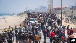 FILE—Displaced Palestinians trying to walk back from central Gaza Strip to northern Gaza Strip, April 14, 2024.