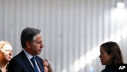 FILE - U.S. Secretary of State Antony Blinken, left, speaks with WFP Deputy Country Director Laurene Goublet during a visit to a World Food Program (WFP) regional warehouse in Amman, Jordan, January 7, 2024.