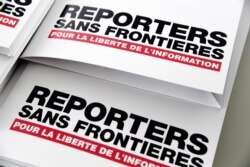 FILE - Press releases are pictured on April 25, 2018, in Paris during a press conference of Reporters Without Borders (RSF) to present its World Press Freedom Index.
