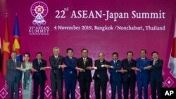 FILE - Japan Prime Minister Shinzo Abe poses for a group photo with ASEAN leaders during an ASEAN-Japan summit in Nonthaburi, Thailand, Nov. 4, 2019.