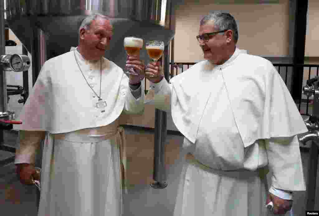 Father Karel Stautemas and abbot Erik toast after blessing beer tanks at the Belgian Abbey of Grimbergen, which returns to brewing after a break of more than 200 years with a new microbrewery in Grimbergen, Belgium, May 26, 2021.