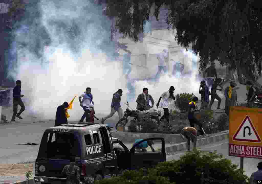 Police fire tear gas to disperse Shiite Muslims during a protest against the killing of Hezbollah leader Hassan Nasrallah, near the U.S. consulate in Karachi, Pakistan.