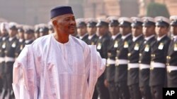 FILE - Malian President Amadou Toumani Toure inspects an honor guard during a ceremonial reception at the Presidential Palace in New Delhi, India, Jan. 11, 2012. Mali's National Assembly rejected plans to try Toure on treason charges on Saturday.