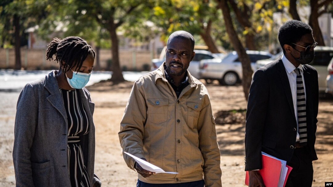 Freelance journalist for the New York Times, Jeffery Moyo, center, leaves the Bulawayo prison in Bulawayo, Zimbabwe, June 16, 2021.