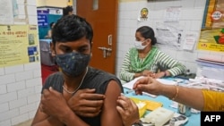 A health worker inoculates a man with a dose of the Covaxin COVID-19 vaccine at a vaccination center in New Delhi, September 14, 2021.