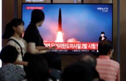 People watch a TV that shows a file picture of a North Korean missile for a news report on North Korea firing short-range ballistic missiles, in Seoul, South Korea, July 31, 2019.