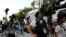 FILE - Journalists are seen gatheed outside St. Regis Hotel in Singapore, June 11, 2018.