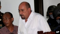 FILE - Serge Atlaoui, a French national who is on death row after being convicted of drug offences, enters the courtroom for his judicial review hearing at the district court in Tangerang, Indonesia, April 1, 2015.