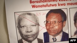FILE: The date of arrest and a red cross are seen written on the face of Felicien Kabuga, one of the last key suspects in the 1994 Rwandan genocide, on a wanted poster at the Genocide Fugitive Tracking Unit office in Kigali, Rwanda, on May 19, 2020.